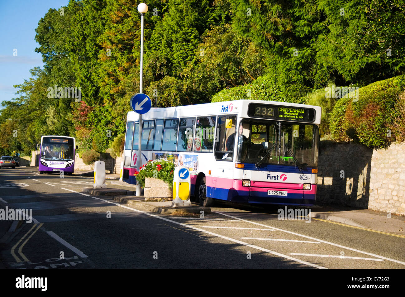 A FirstGroup bus followed by competitor Faresaver bus travel through Batheaston Somerset Stock Photo