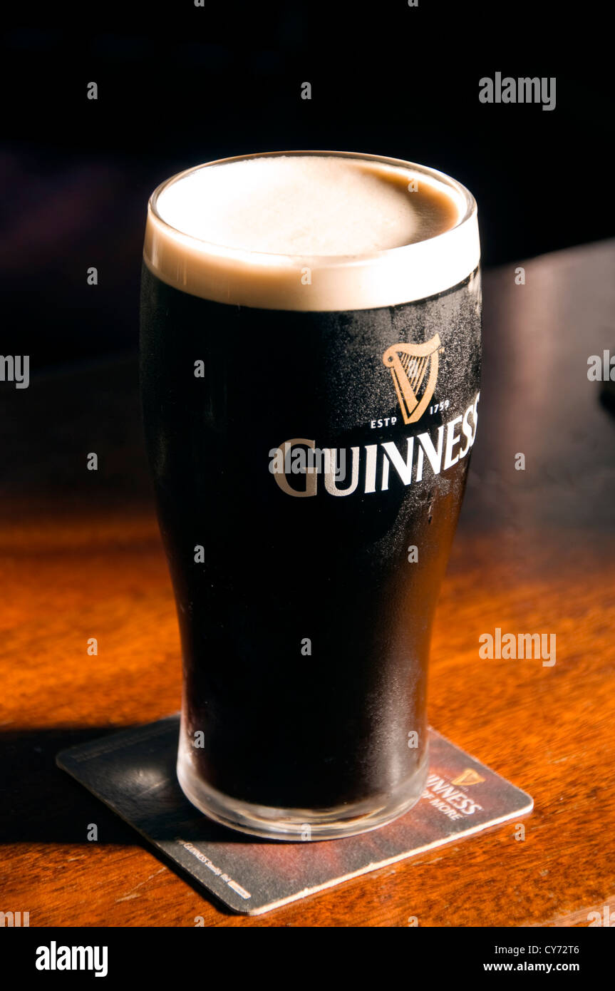 Pint of Irish Stout on a wooden bar Stock Photo