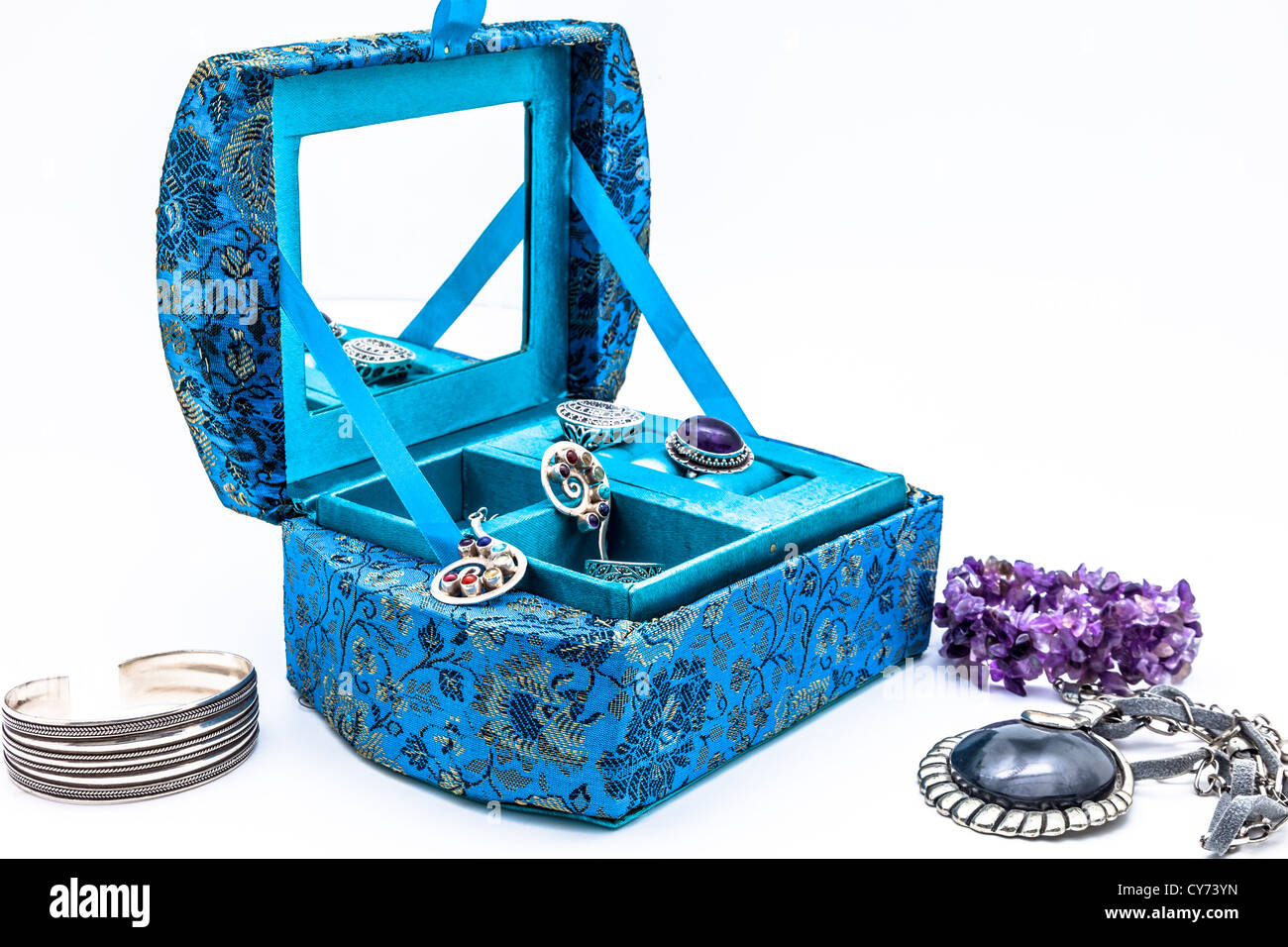 A composition of a blue jewel box on a white background Stock Photo Alamy