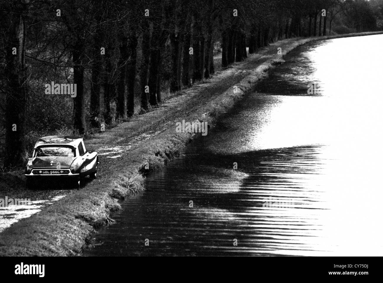 Citroen DS19 driving along a country road by the Burgundy canal in central France Stock Photo