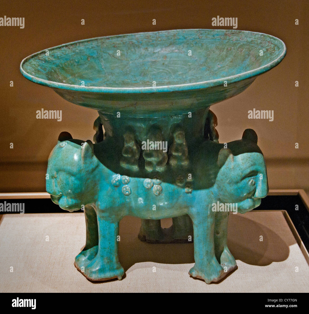Bowl on a Base of Three Molded Lions 12th–13th century Iran Stonepaste molded monochrome glazed 35 cm Ceramics Iran Stock Photo