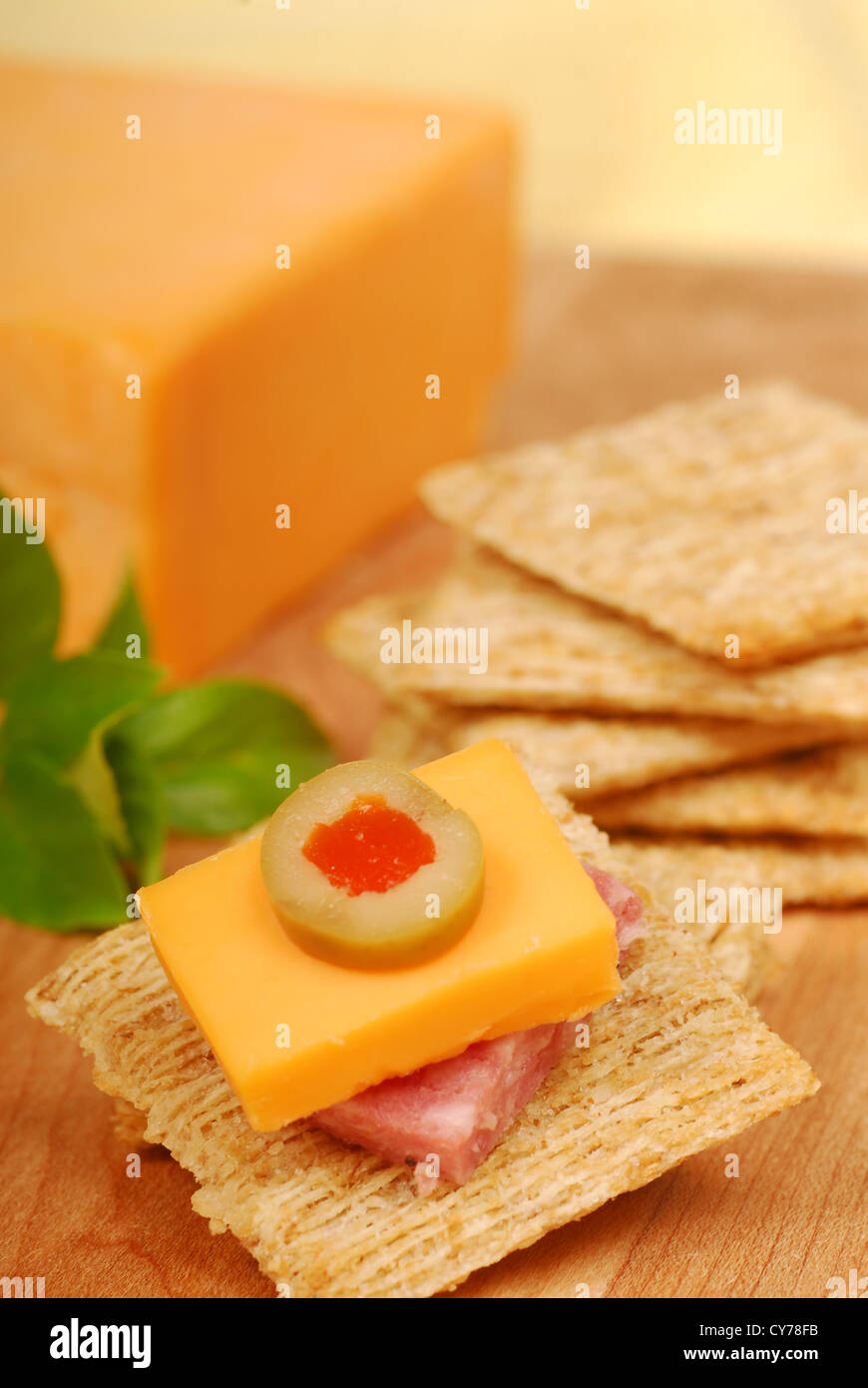 Cheddar cheese and salami on a whole wheat cracker served as an appetizer. Stock Photo