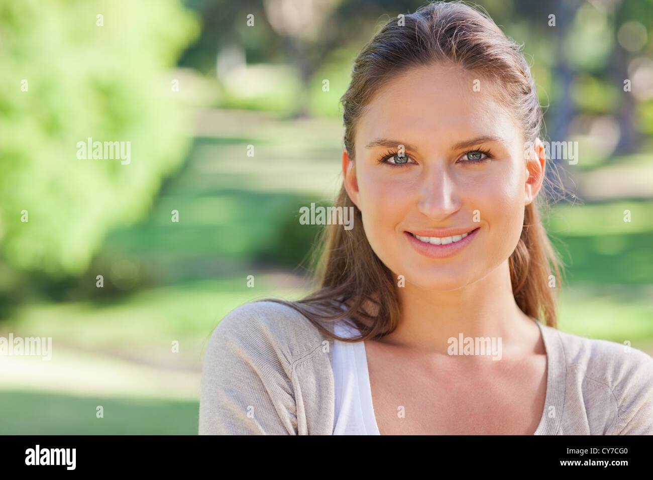 Cheerful smiling woman in the park Stock Photo - Alamy
