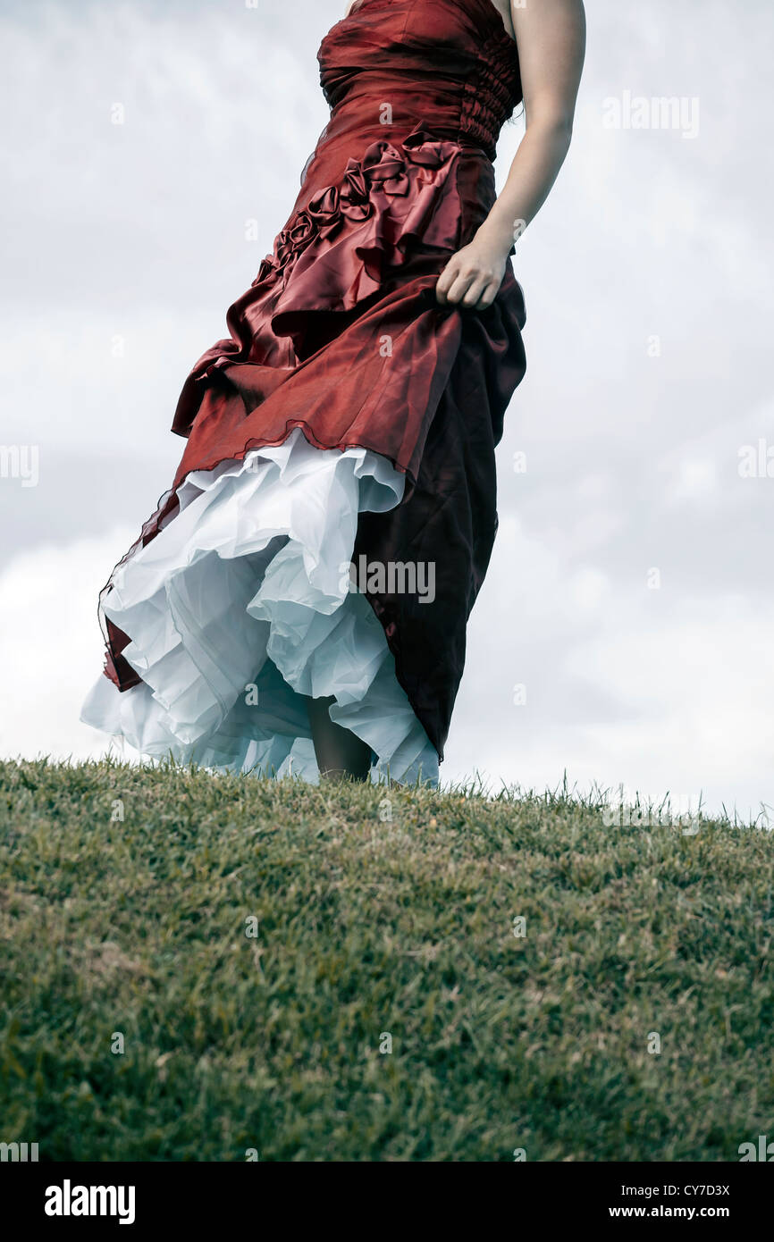 a woman in a red dress on a meadow Stock Photo