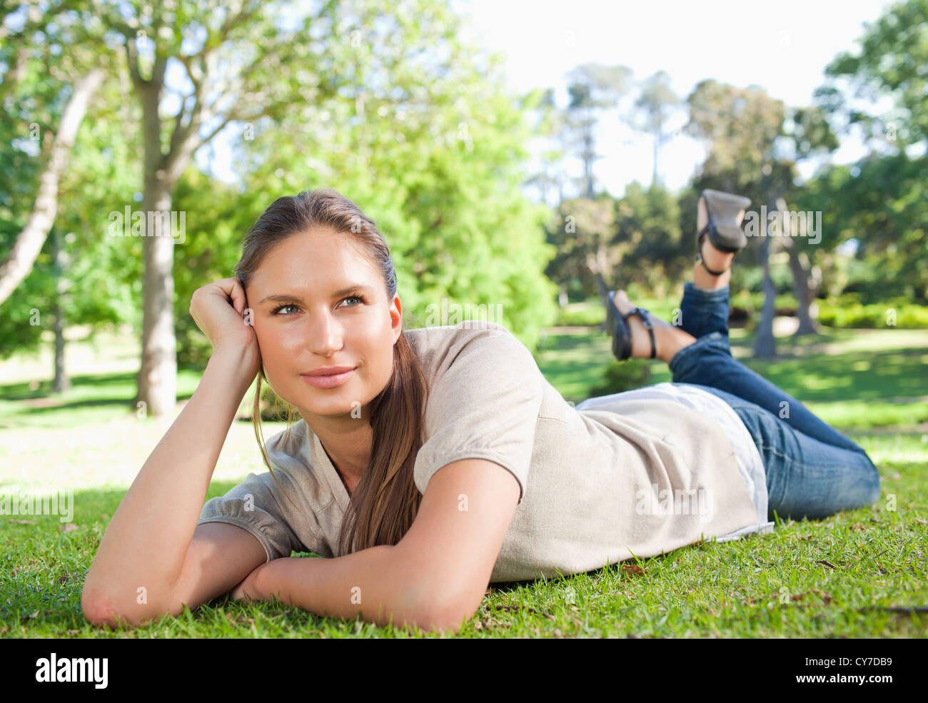 Relaxed woman lying on the grass Stock Photo - Alamy