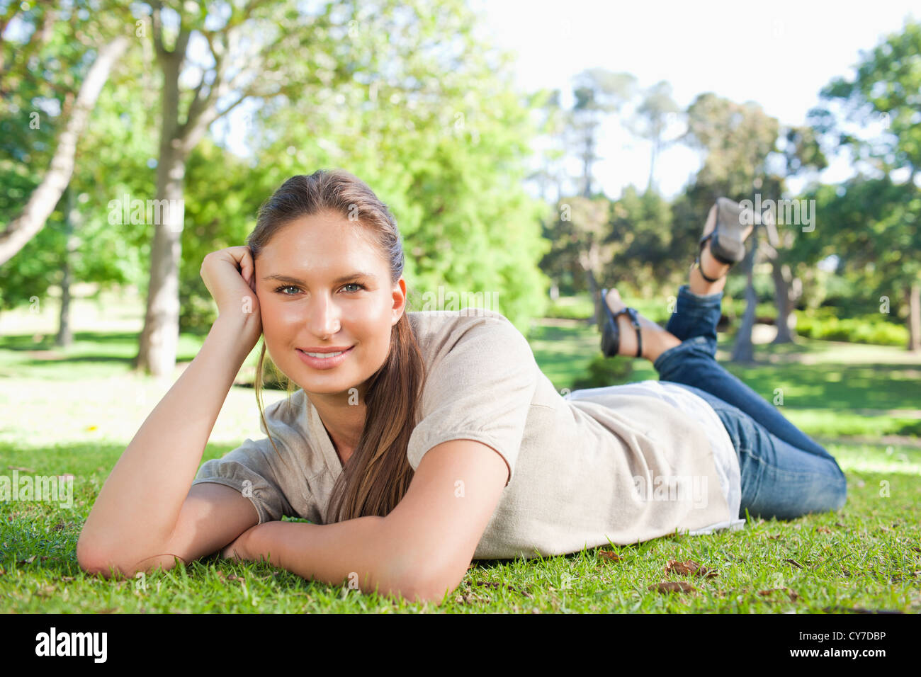 Relaxed woman lying in the park Stock Photo - Alamy