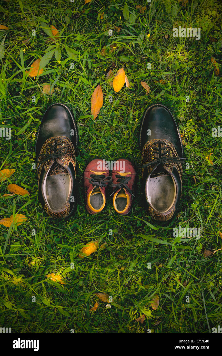 father and child - a pair of man's shoes and a pair of child's shoes Stock Photo