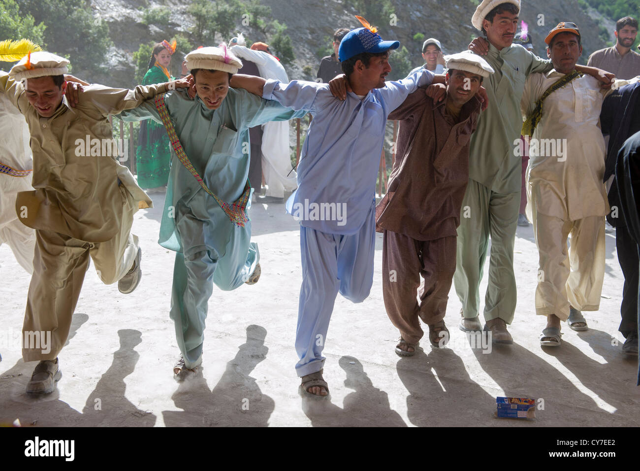 Kalash men dancing in a line at the Kalash Joshi (Spring Festival), Grum Village Charso (dancing ground), Rumbur Valley, Chitral, Khyber-Pakhtunkhwa, Pakistan Stock Photo