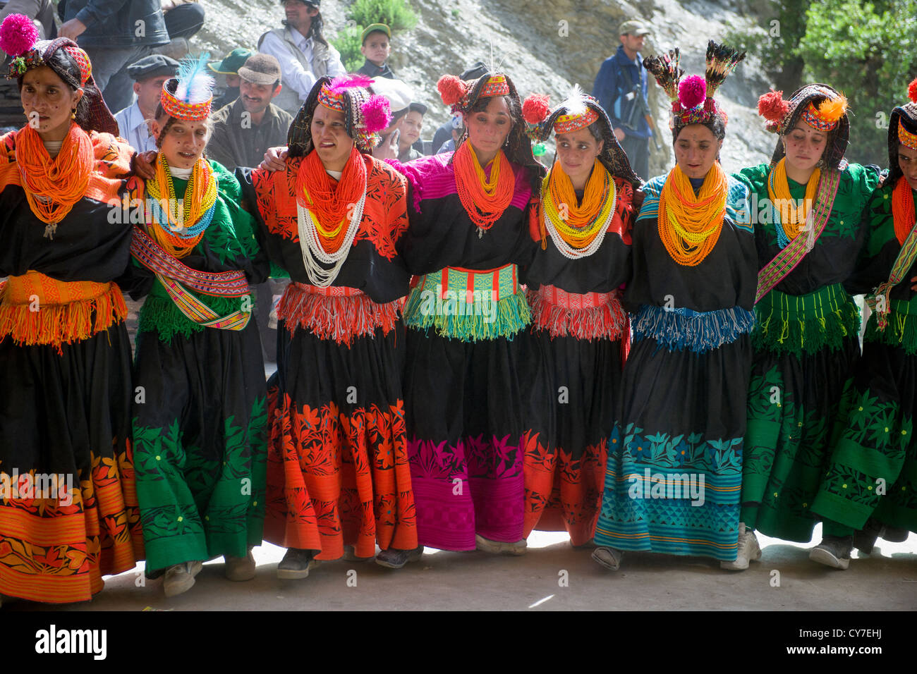 Kalash women dancing in a line at the Kalash Joshi (Spring Festival), Grum Village Charso (dancing ground), Rumbur Valley, Chitral, Khyber-Pakhtunkhwa, Pakistan Stock Photo