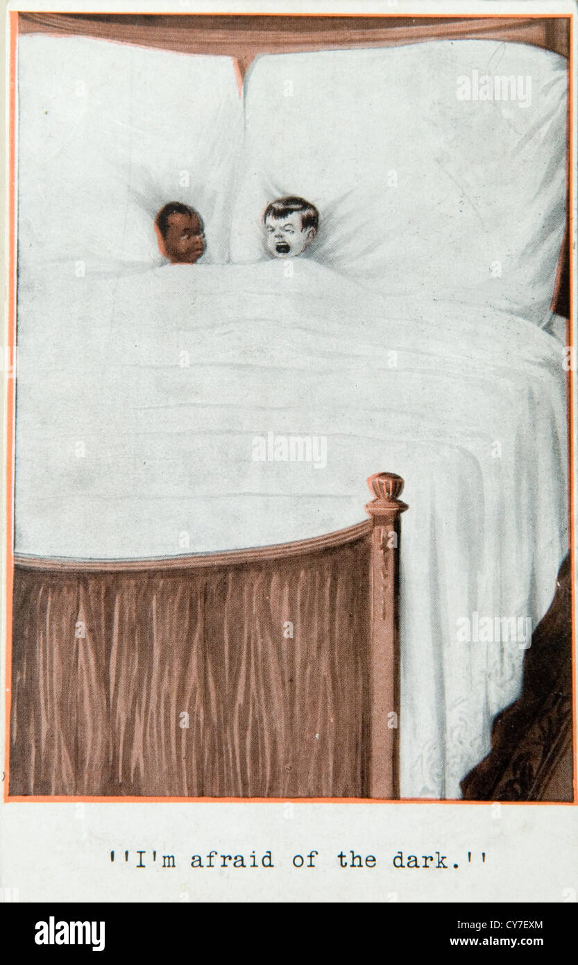 Vintage 1910s postcard 'I'm afraid of the dark.' Racist bad improper non pc joke by todays standards Stock Photo