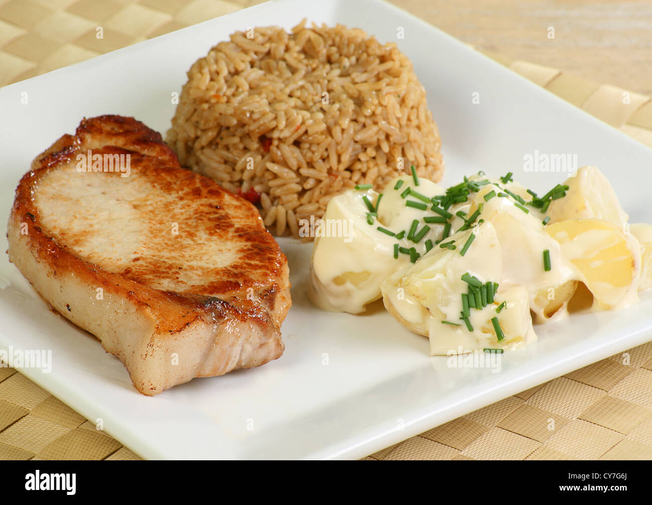grilled pork loin steak with rice and potato salad Stock Photo Alamy