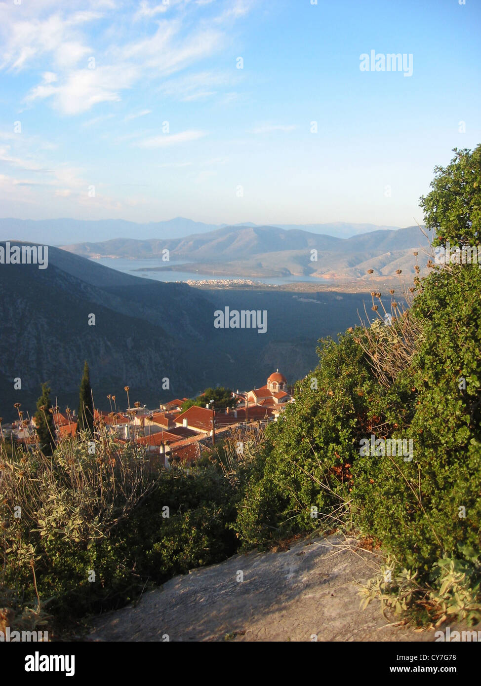 View over the rooftops of the modern Greek village of Delfi ( Delphi ) towards the Gulf of Corinth. The archaeological site Stock Photo