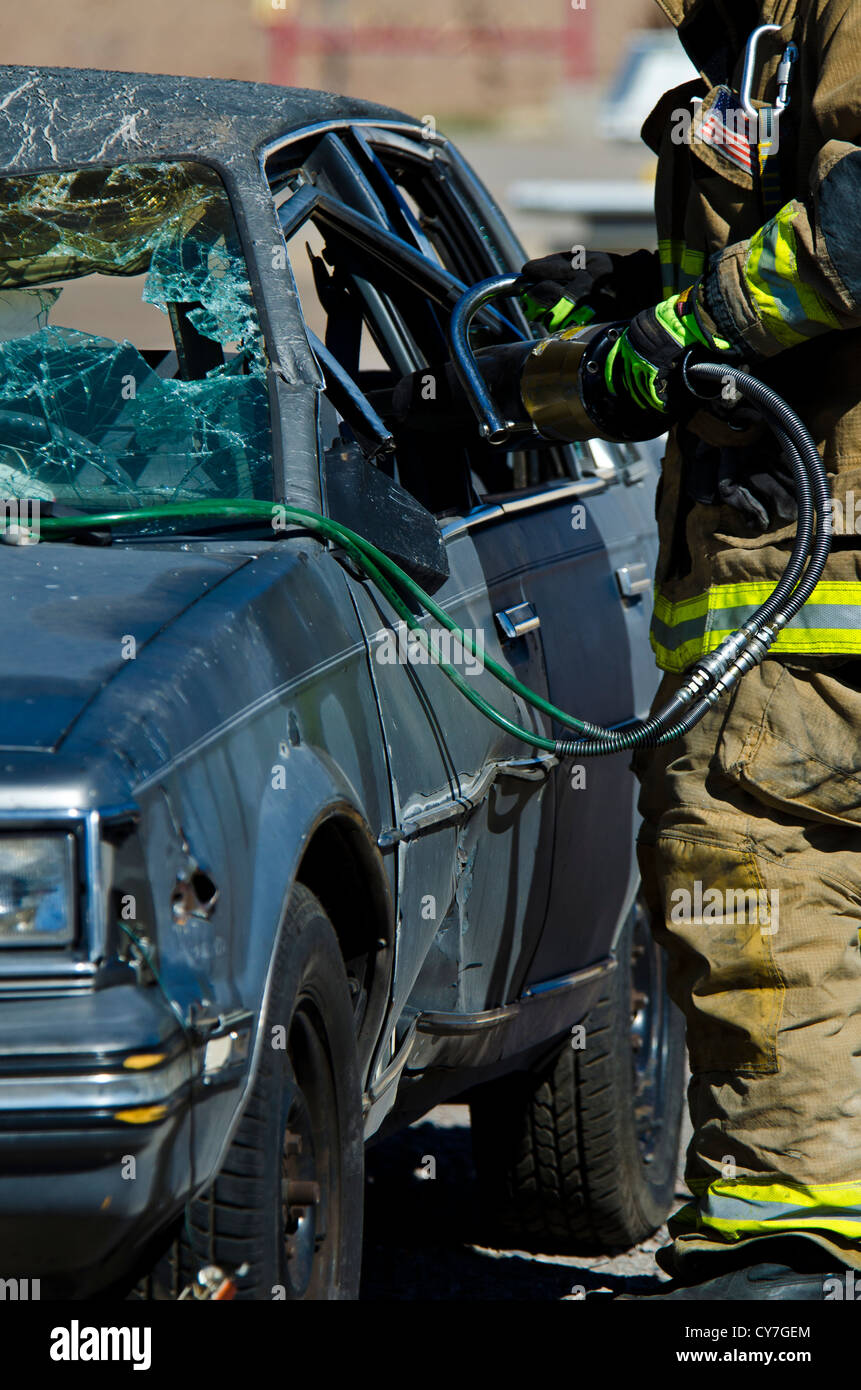 Firemen using the Jaws of Life at a car wreak. Tempe, AZ. Stock Photo