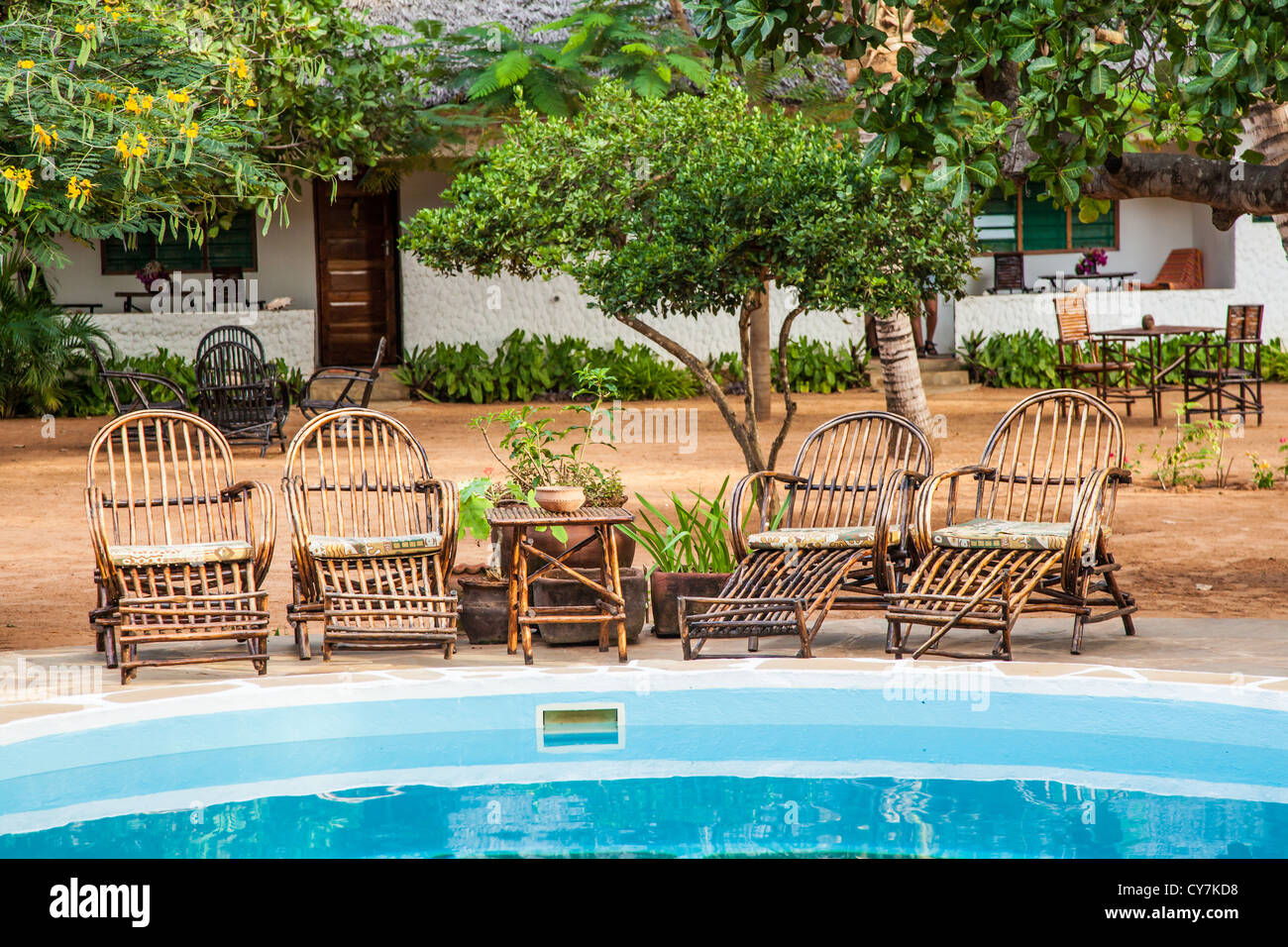 Elegant chairs made of wood close to a swimming pool inside a Kenyan garden Stock Photo Alamy