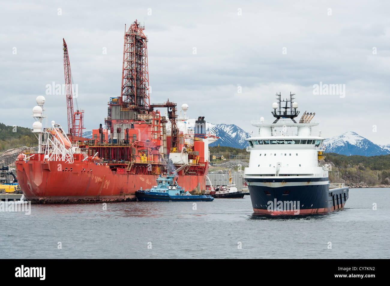 Drill ship and supply boat in Norwegian Fjord Stock Photo