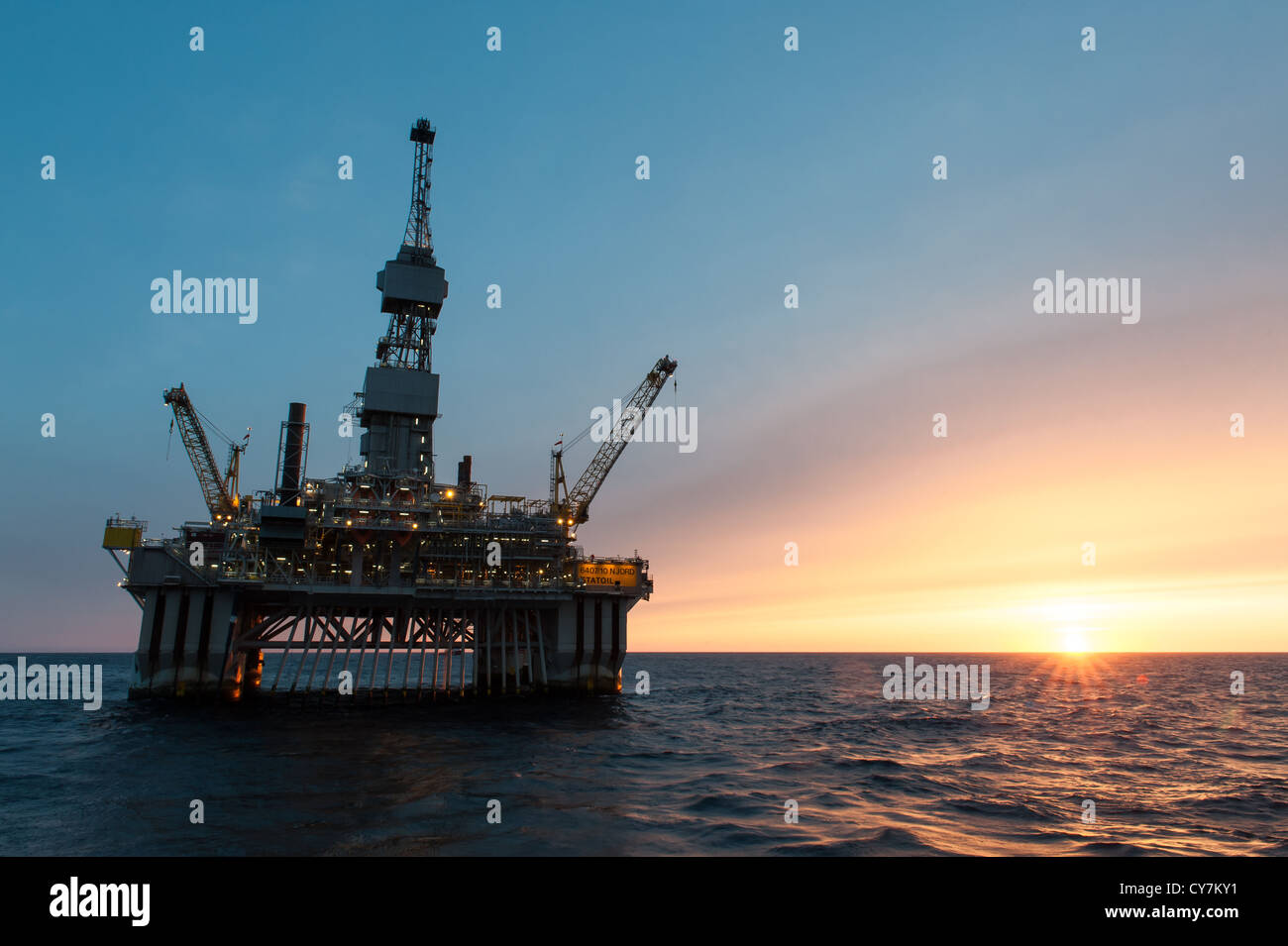 Oil rig at sun set in the North Sea Stock Photo