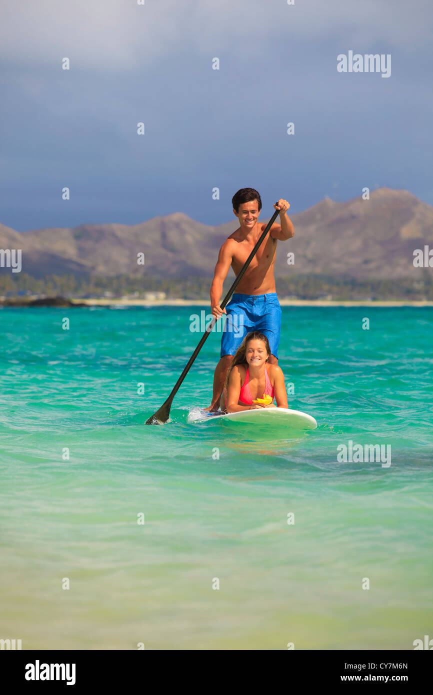couple on standup paddle board in hawaii Stock Photo Alamy