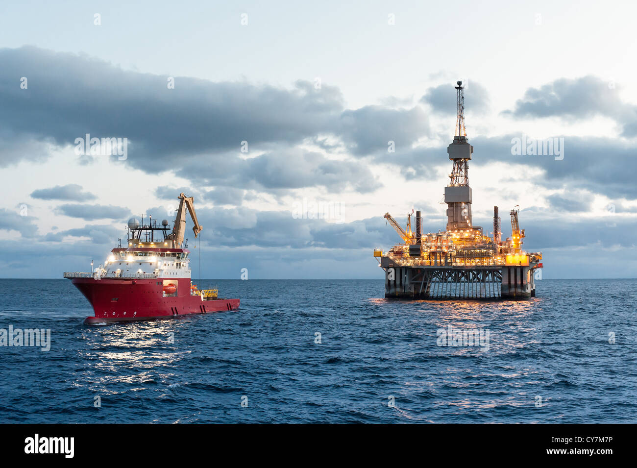 Oil rig with Supply boat in the north Sae Stock Photo