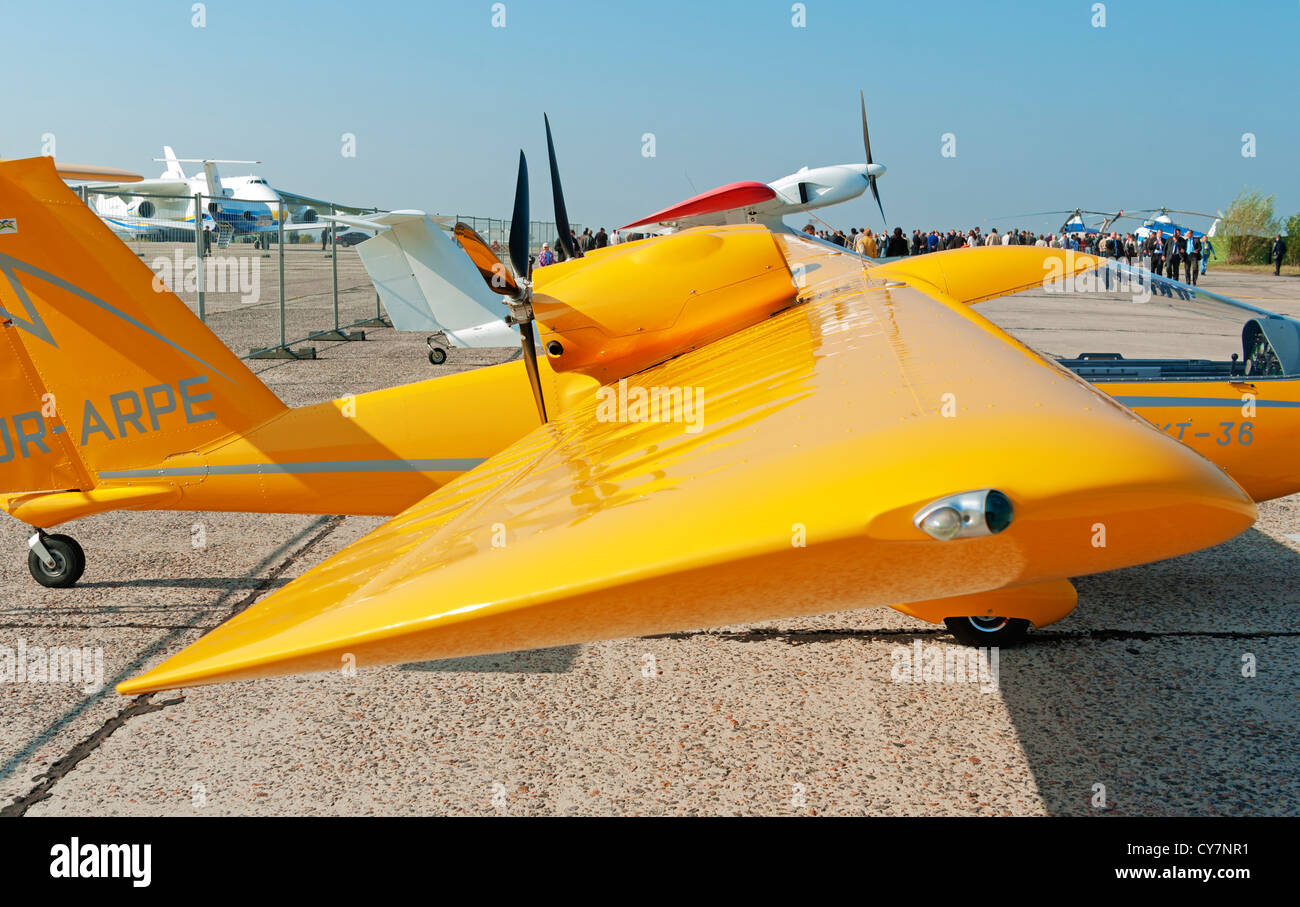 Light two-engine airplane for cruising and training on yellow colour - wing view. Stock Photo