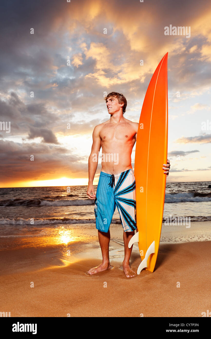 Professional Surfer holding a Surf Board Stock Photo - Alamy