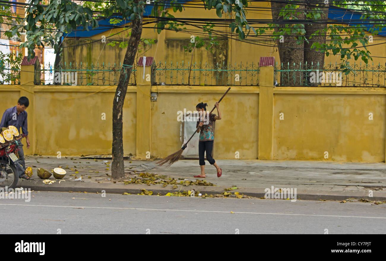 Vietnamese lady sweeping path broom hires stock photography and images