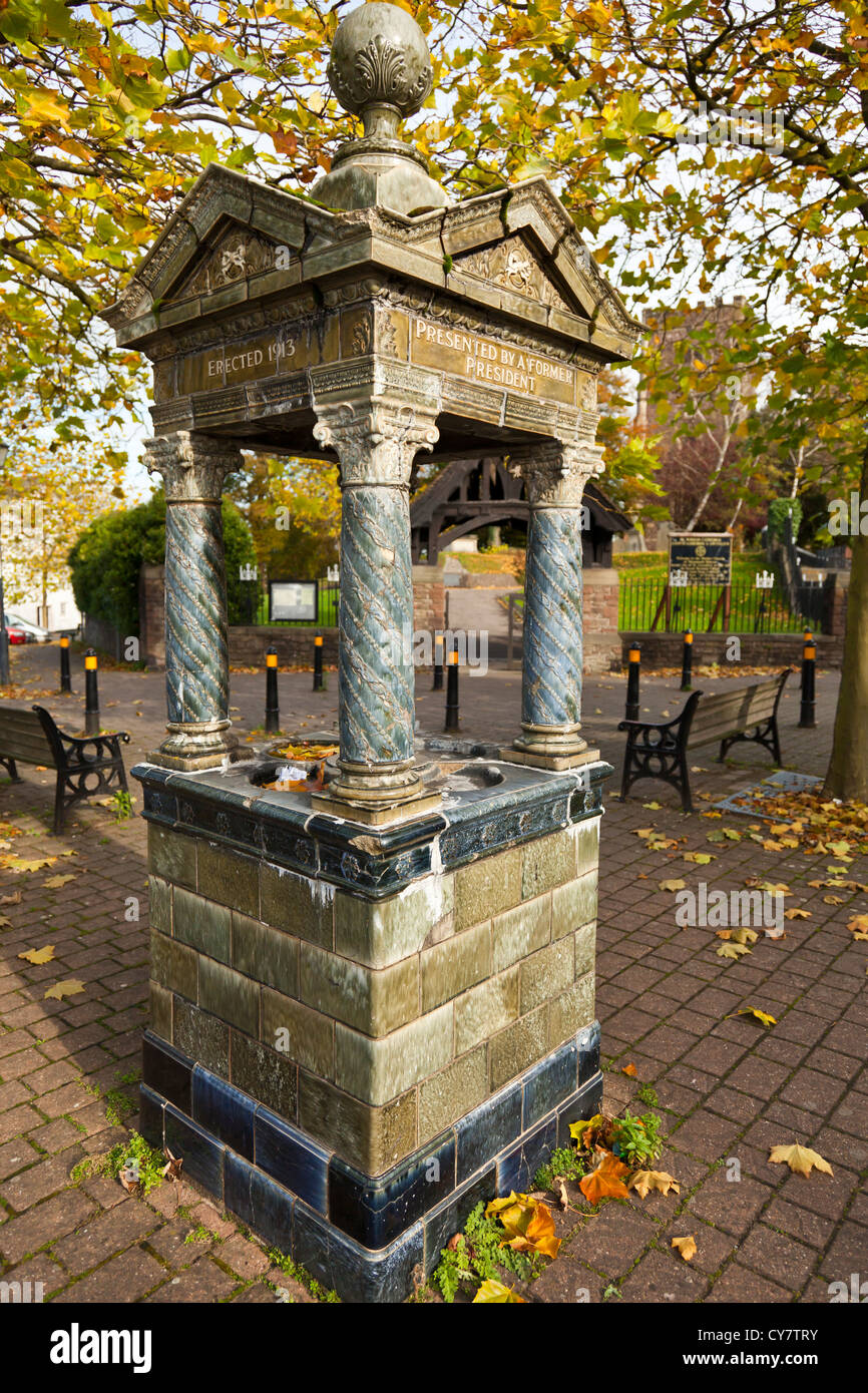 Public well fountain built in ceramic glazed ornate tiles, by 'The British Womans Temperance Association' St Woolas Cathedral. Stock Photo