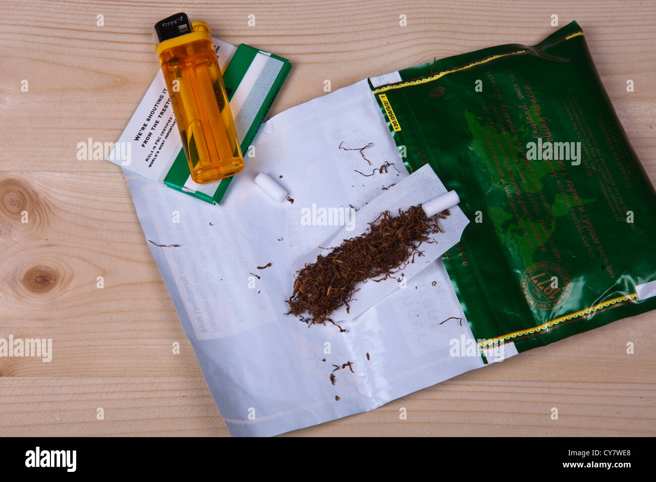 Hand rolling tobacco for making cigarettes Stock Photo Alamy