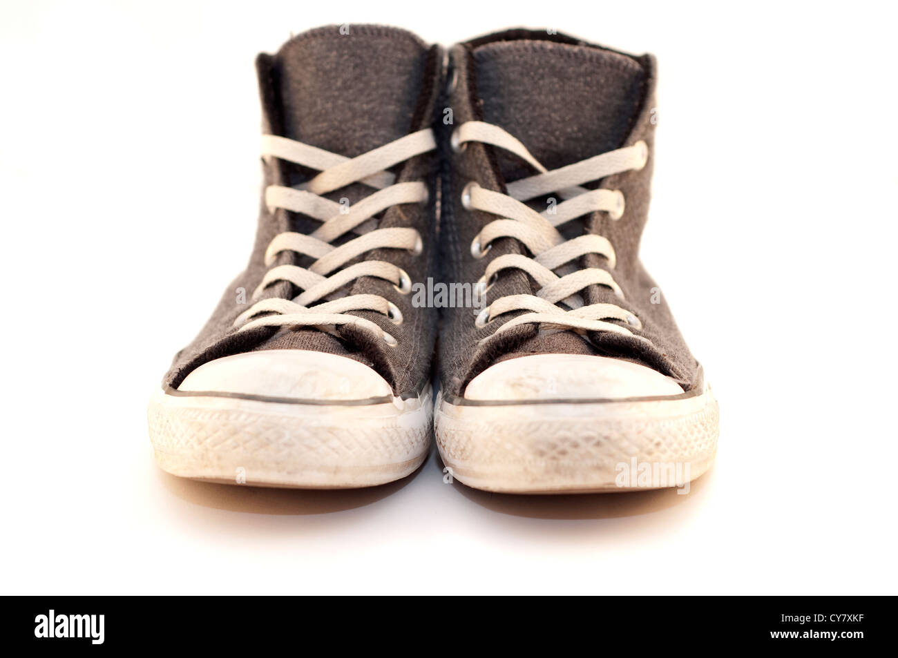 A pair of old sneakers, isolated on white background Stock Photo - Alamy