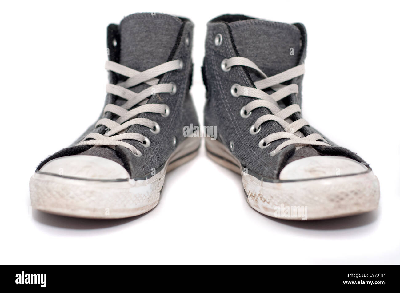 A pair of old sneakers, isolated on white background Stock Photo - Alamy