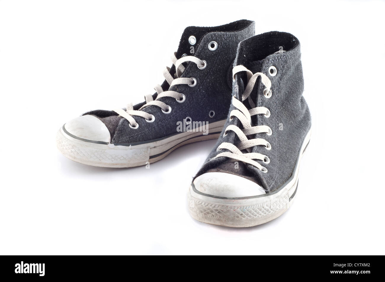 A pair of old sneakers, isolated on white background Stock Photo - Alamy