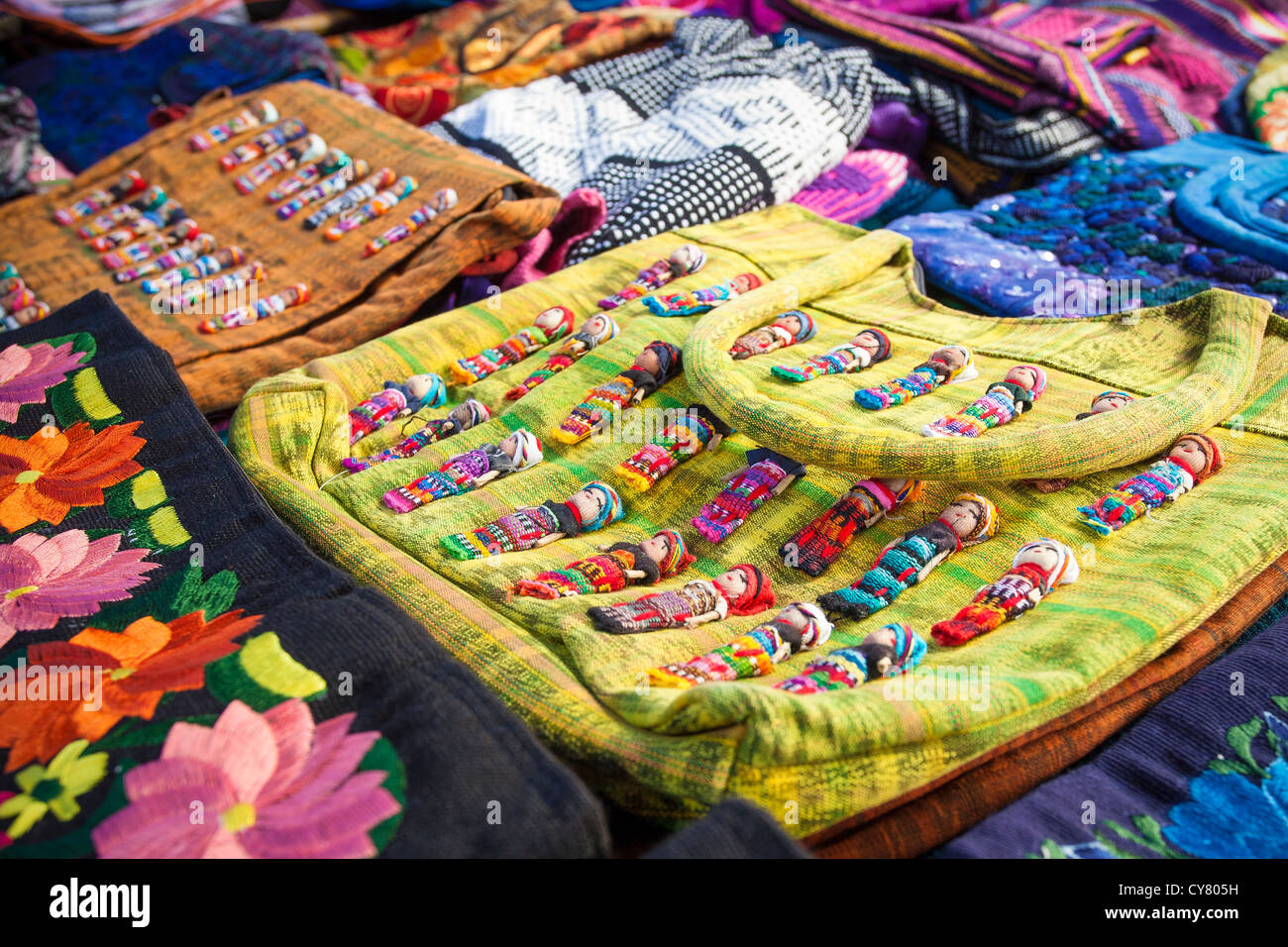 Stitched dolls decorate purses at the Tlacolula, Oaxaca market in Mexico. Stock Photo