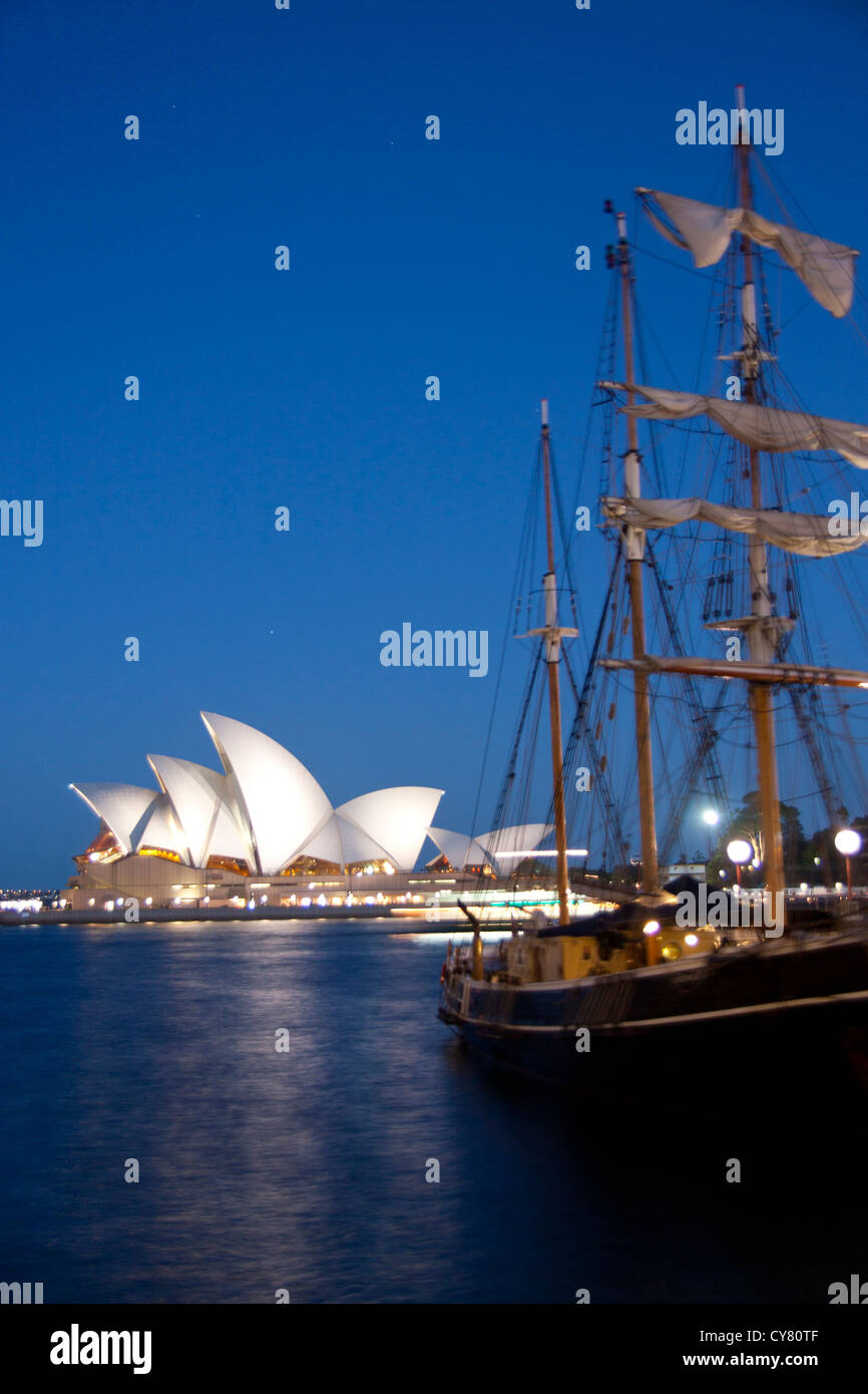 Sydney Opera House at twilight from Campbells Cove with historic tall ship in right foreground Sydney New South Wales Australia Stock Photo