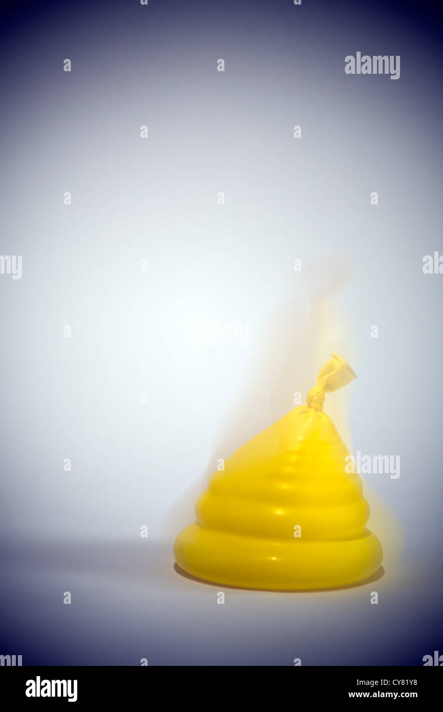 Yellow Balloon Filled With Water Being Dropped Stock Photo