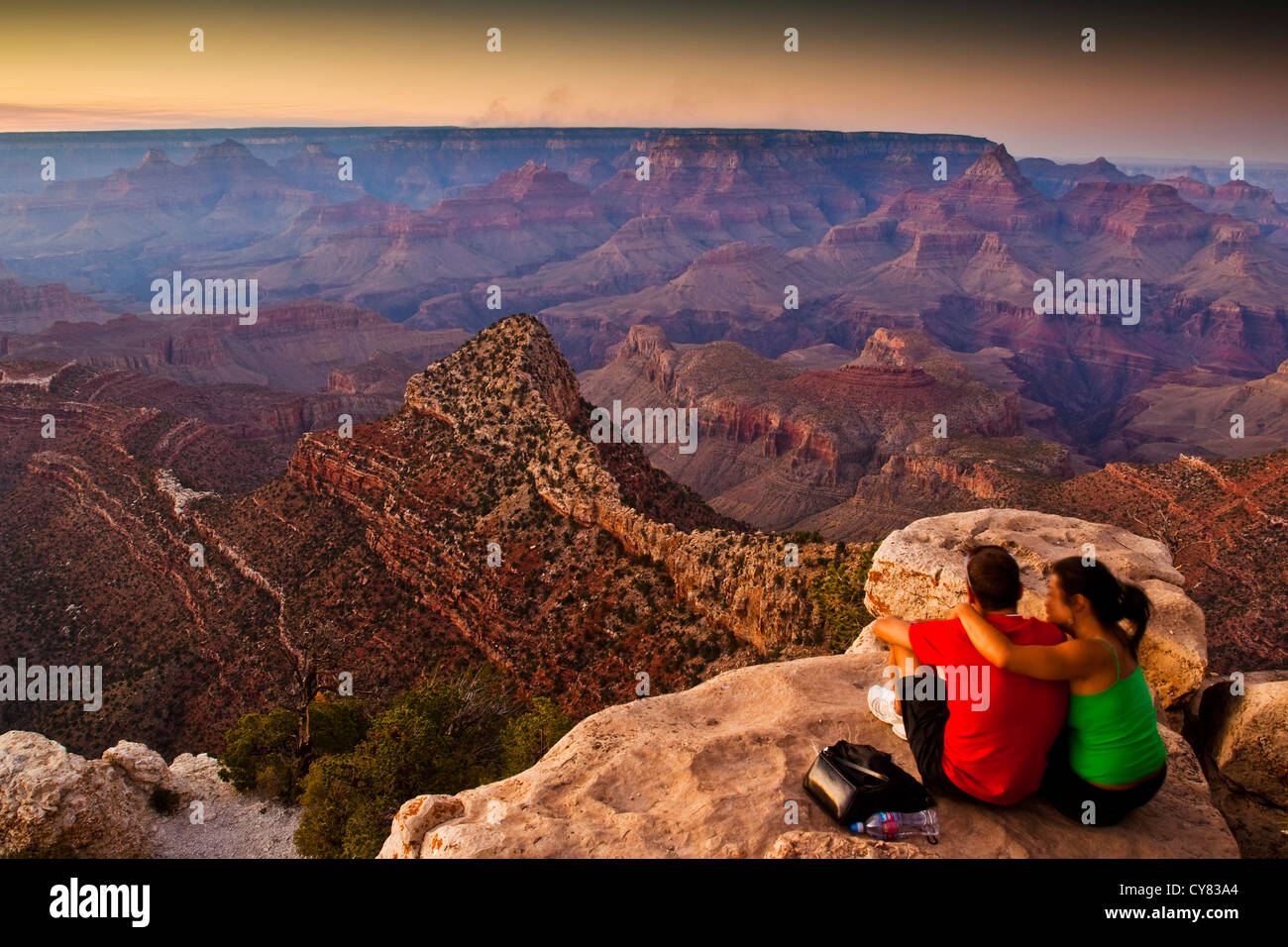 Tourist couple watching the sunset from Grandview Point, South Rim, Grand Canyon National Park, Arizona Stock Photo