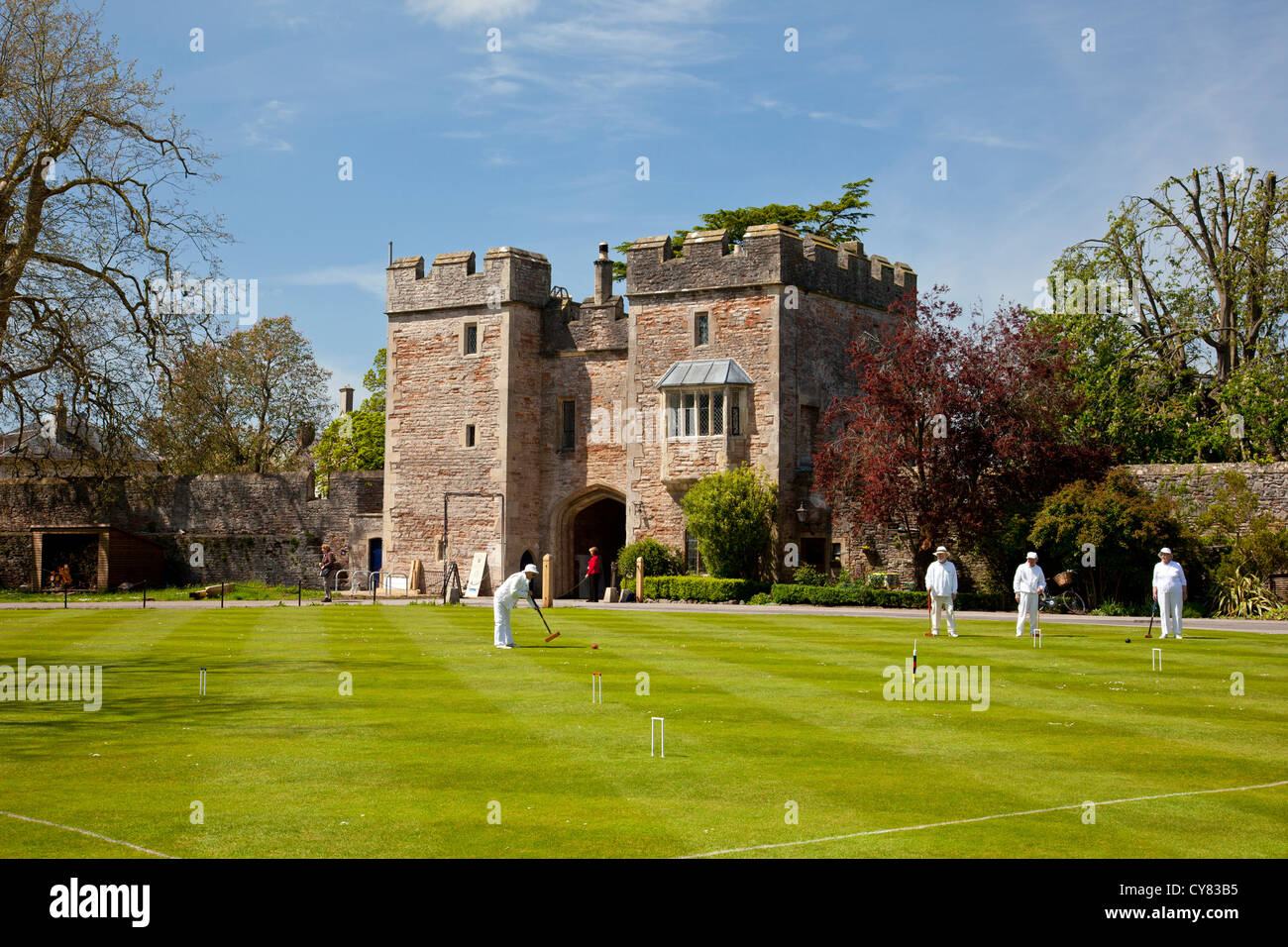 Croquet on the lawn inside the Bishop's Palace grounds at Wells, Somerset, England, UK Stock Photo