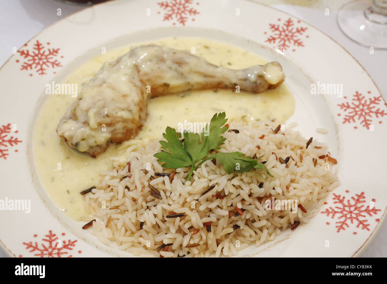 Classic French Chicken in White Wine Sauce with rice, served in French
