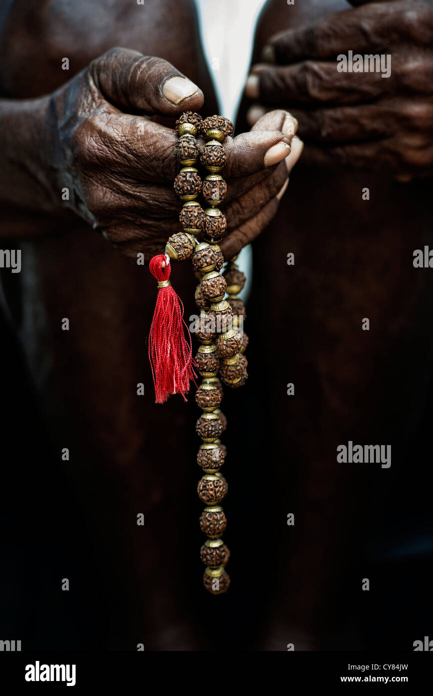 Old Indian mans hand holding Indian Rudraksha / Japa Mala prayer beads  Stock Photo - Alamy