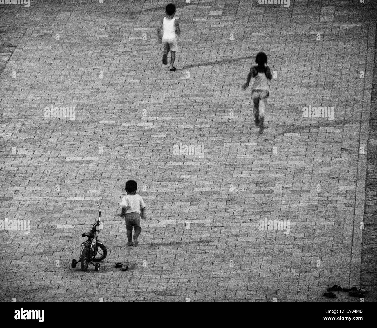 Children playing outside the 16th Century Kalon Mosque Bukhara Uzbekistan Stock Photo