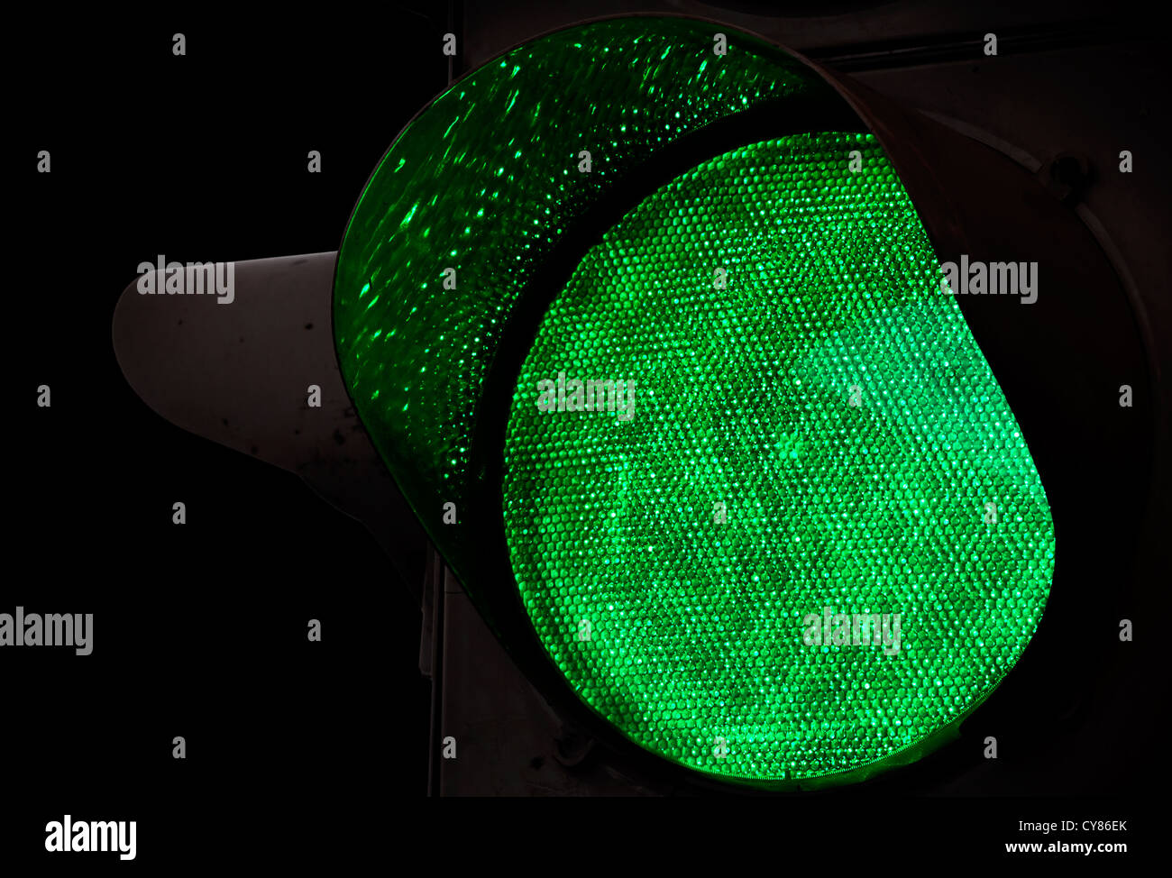 Green traffic light closeup photo above black background Stock Photo