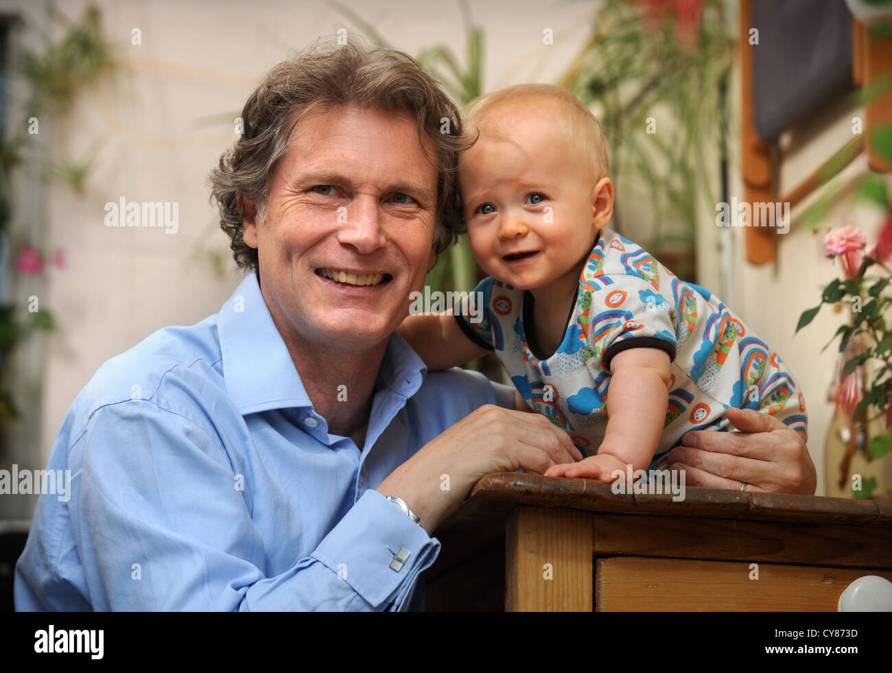 A middle aged father with his baby UK Stock Photo
