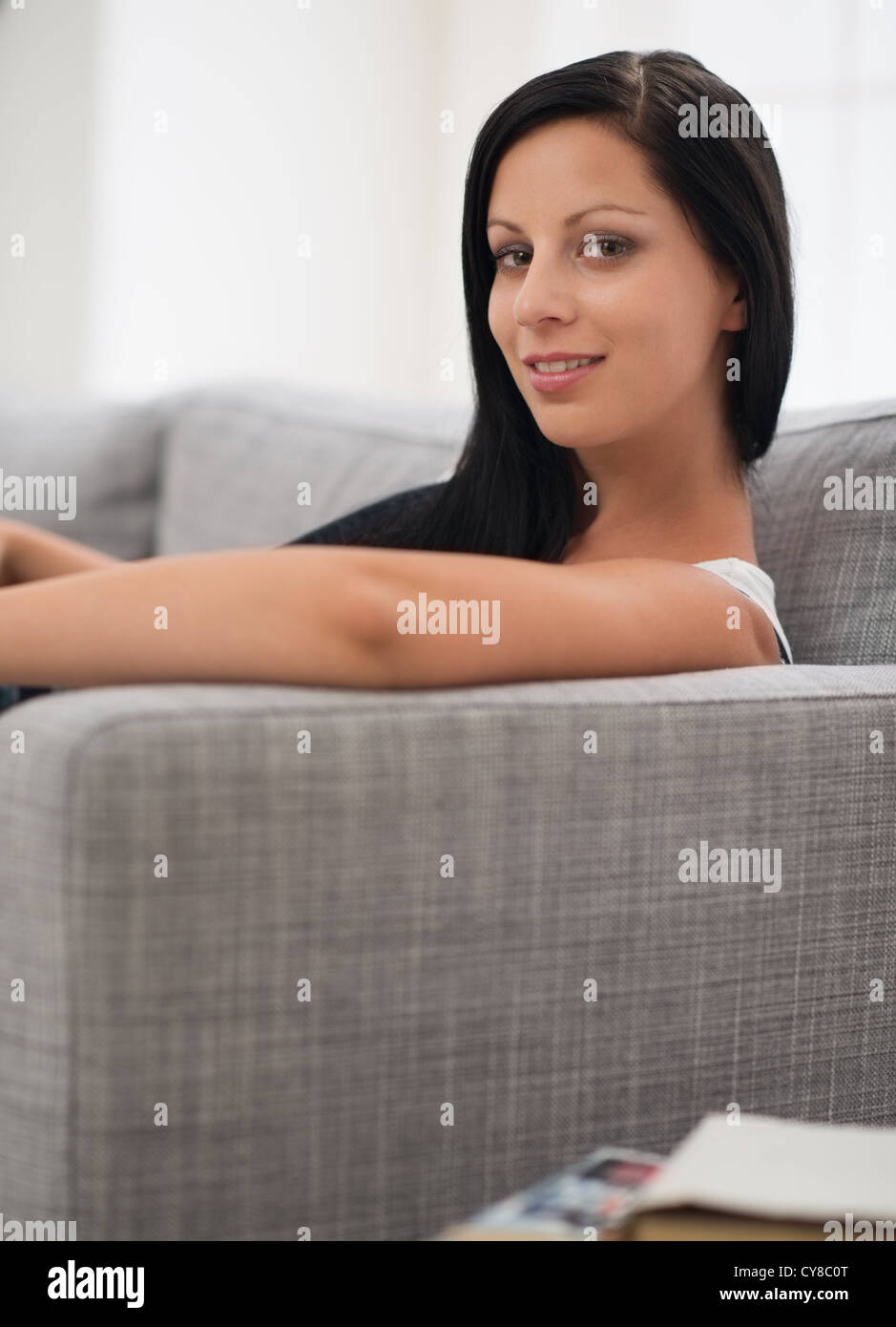 Happy girl laying on couch Stock Photo