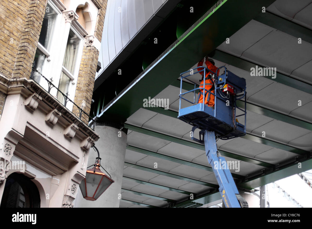 Workman on a cherry picker in London Stock Photo Alamy
