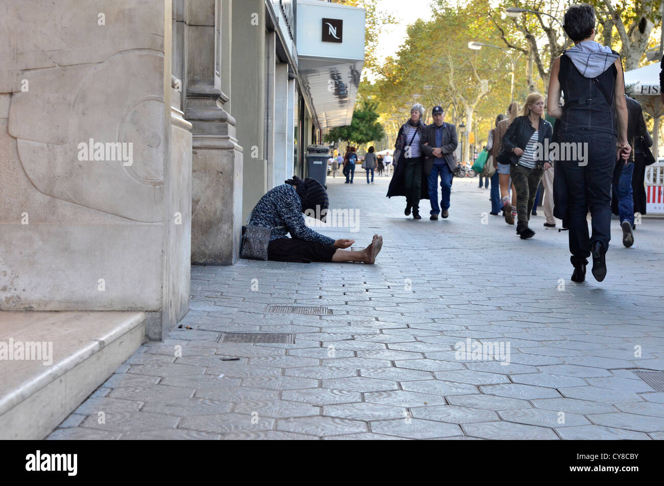 Outcast woman begging in passeig gràcia in Barcelona Stock Photo