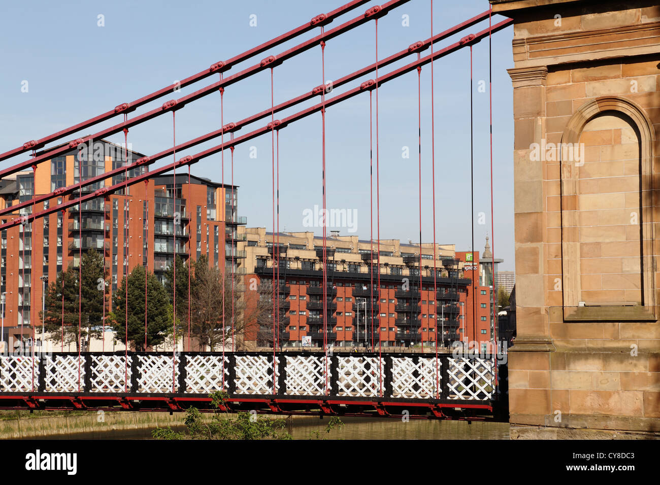 Looking through South Portland Street Suspension Bridge to modern