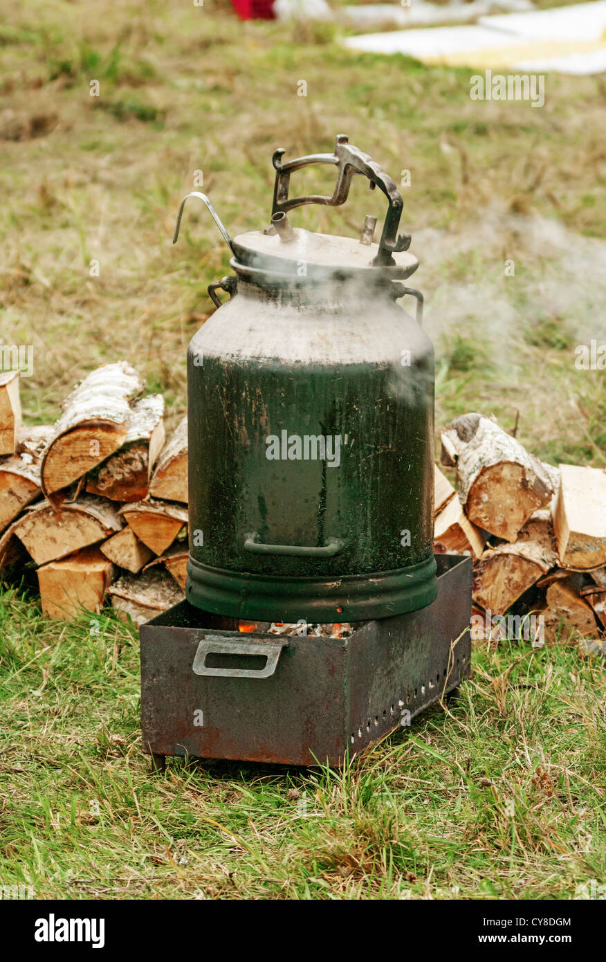 Boiling water on campfire Stock Photo Alamy