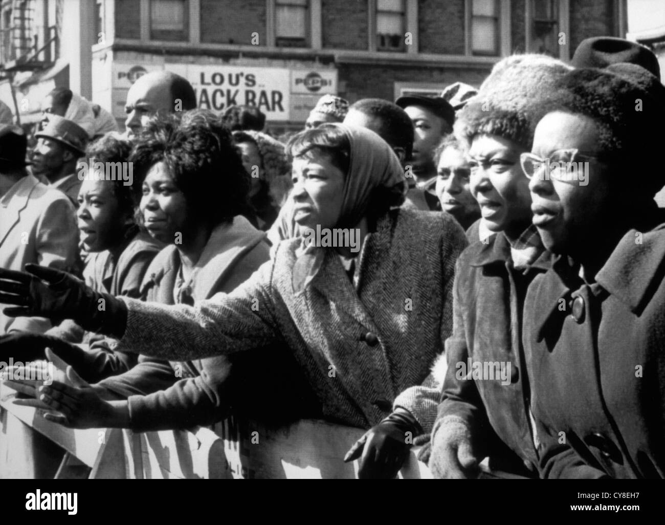 Upset African-American Women Waving Farewell to Slain Leader, Malcolm X, at Faith Temple, New York City, USA, February 27, 1965 Stock Photo
