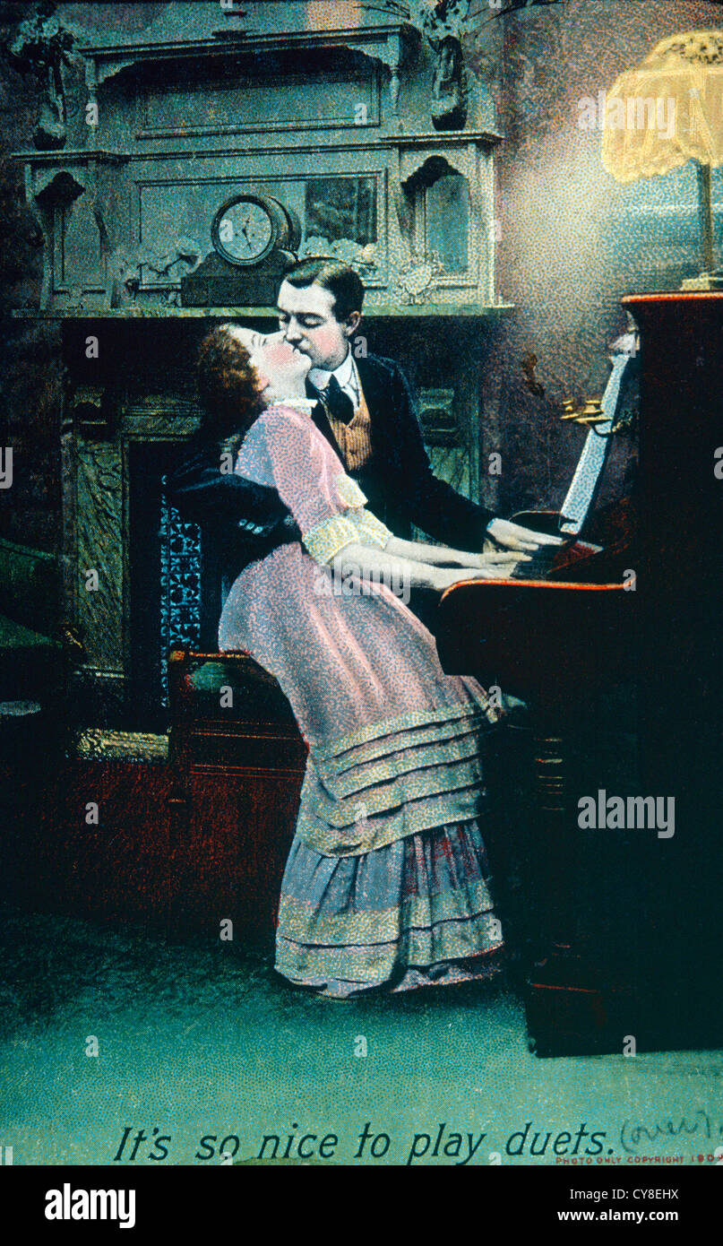 Man Kissing Woman at Piano, Circa 1910 Stock Photo