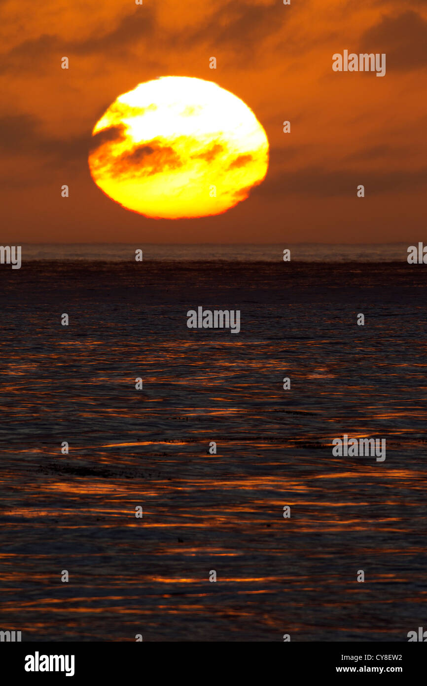 Large Sun Setting over the Pacific Ocean Stock Photo