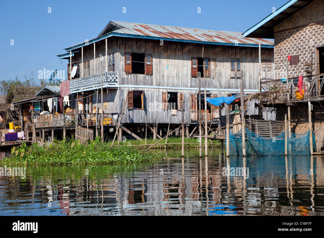 Myanmar, Burma. Traditional House on Stilts, Inle Lake, Shan State. Note blue satellite dish on left. Stock Photo