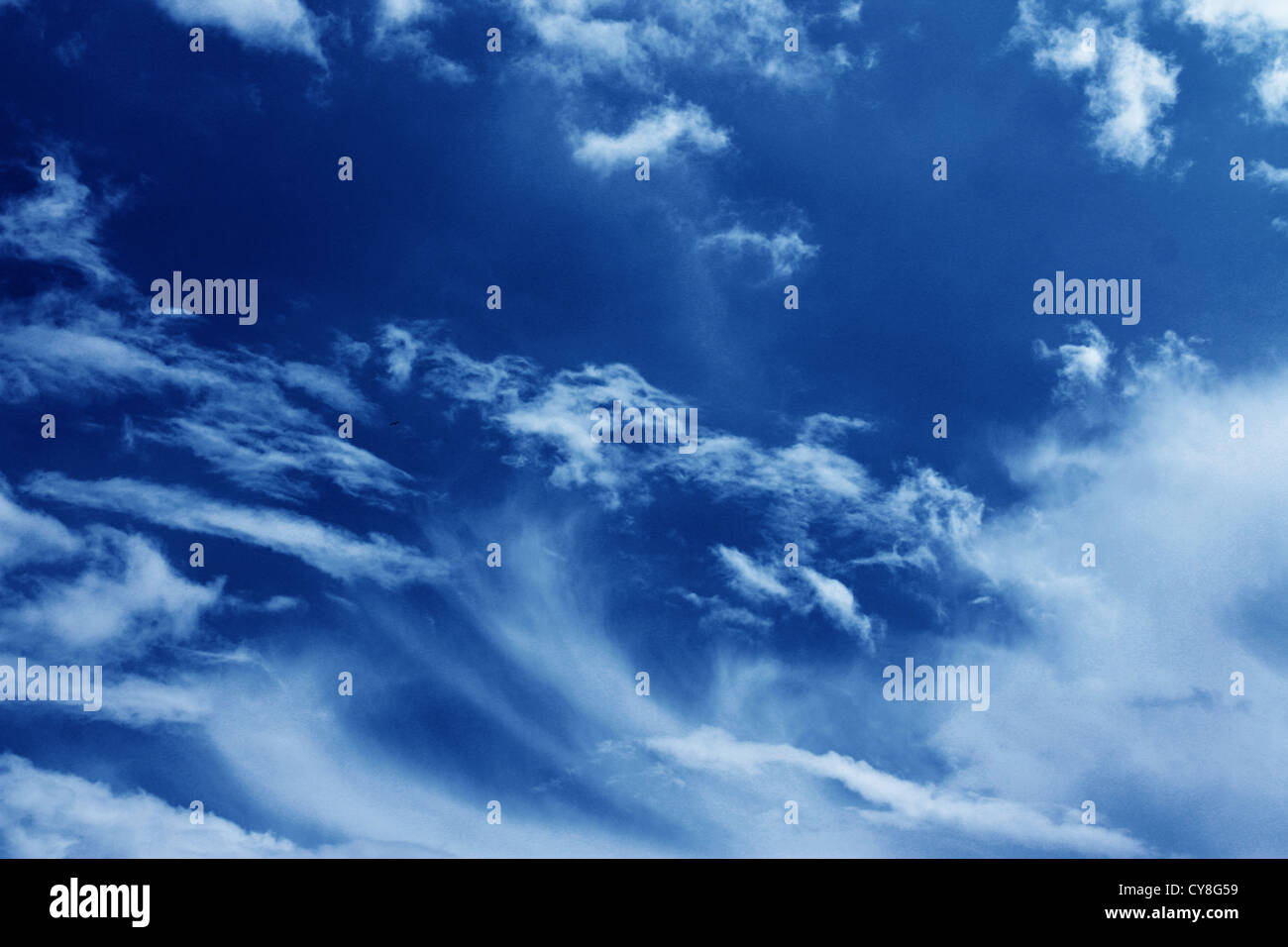 blue abstract background, dark blue sky with white clouds as atmosphere